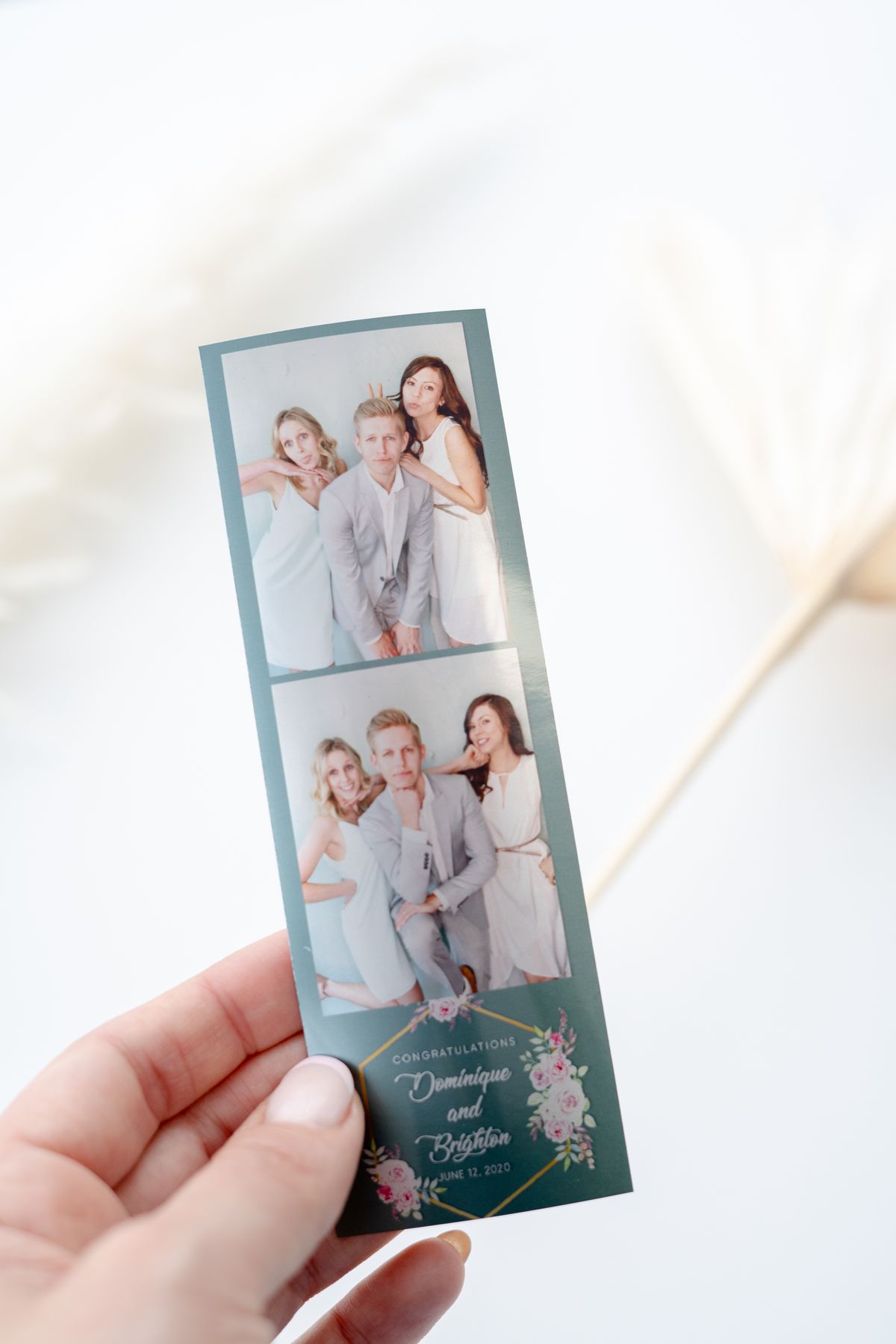 Guest holding a custom 2x6 photo strip