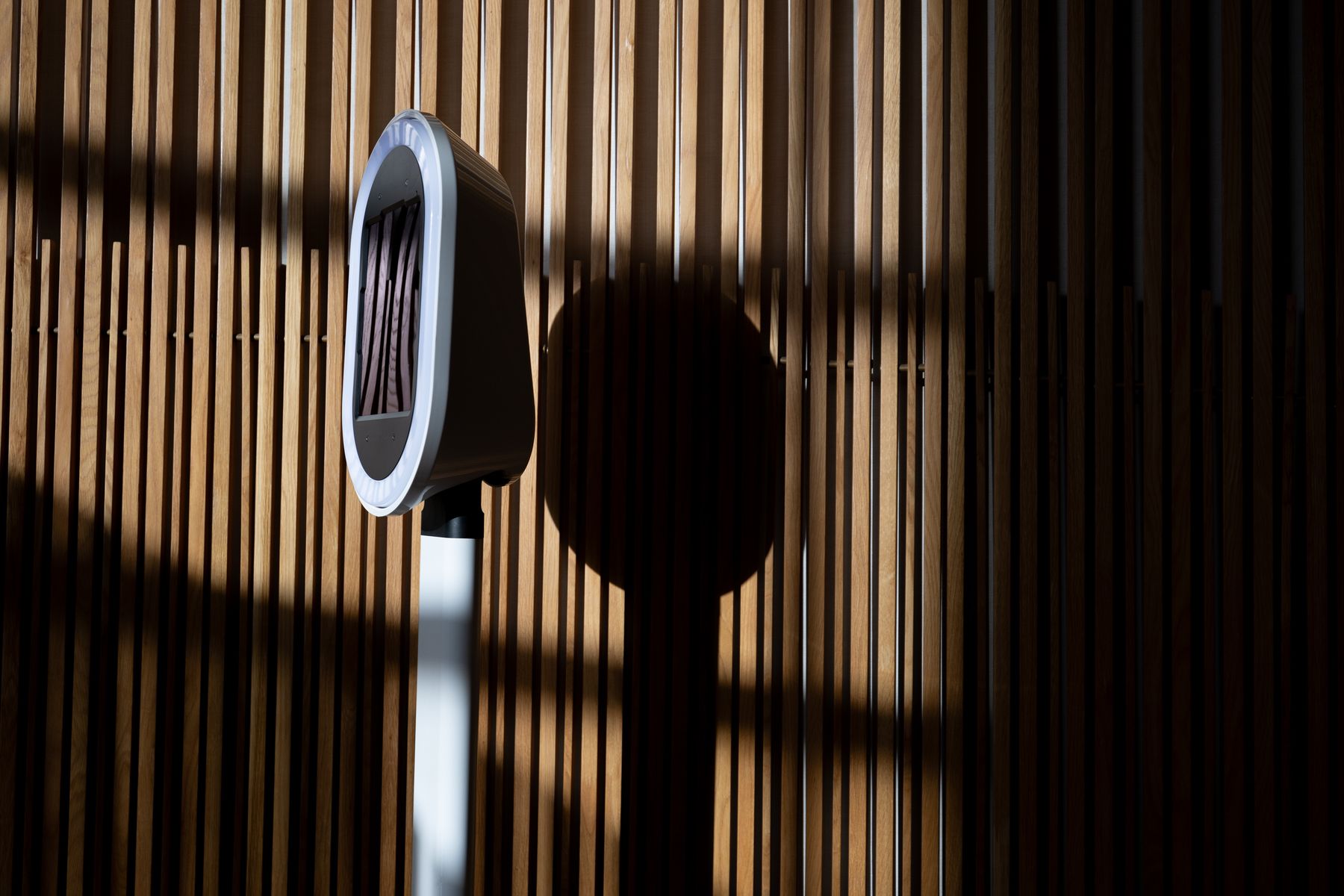 Digital photo booth with its glowing light ring in a dimly lit venue